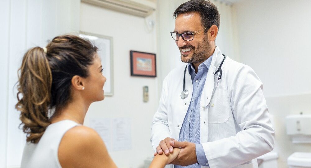 Healthcare and medical concept - doctor with patient in hospital. Doctor working in the office and listening to the patient, she is explaining her symptoms, healtcare and assistance concept